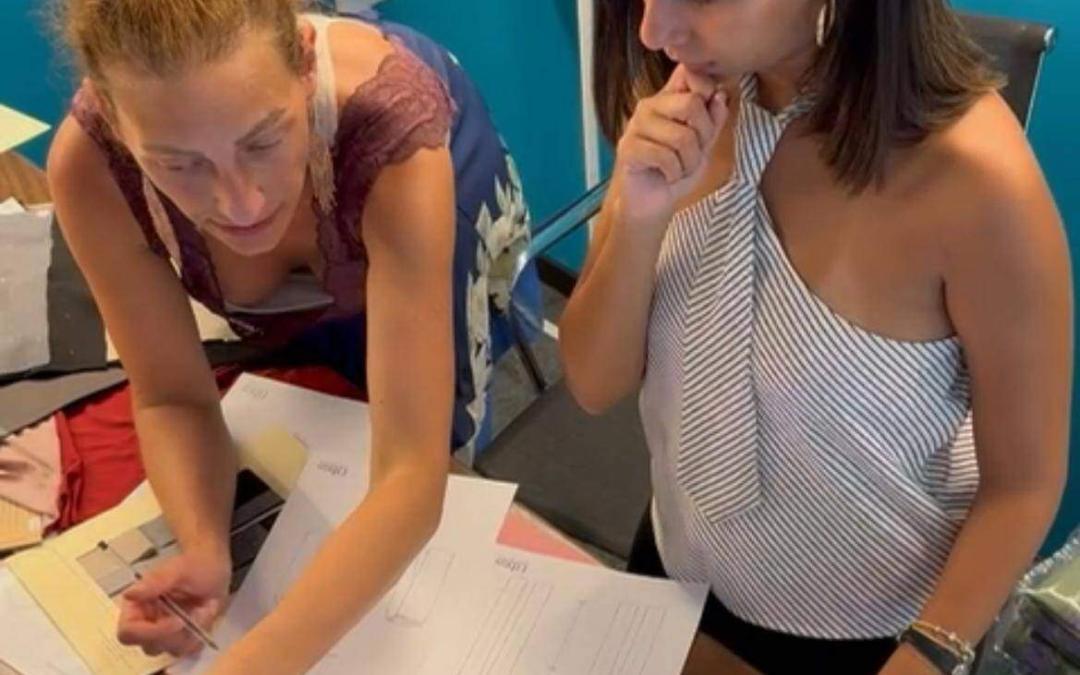 Two women work together at a desk, examining papers and using a laptop for reference. Pre-Production Sample: Prototype Approval to Bulk
